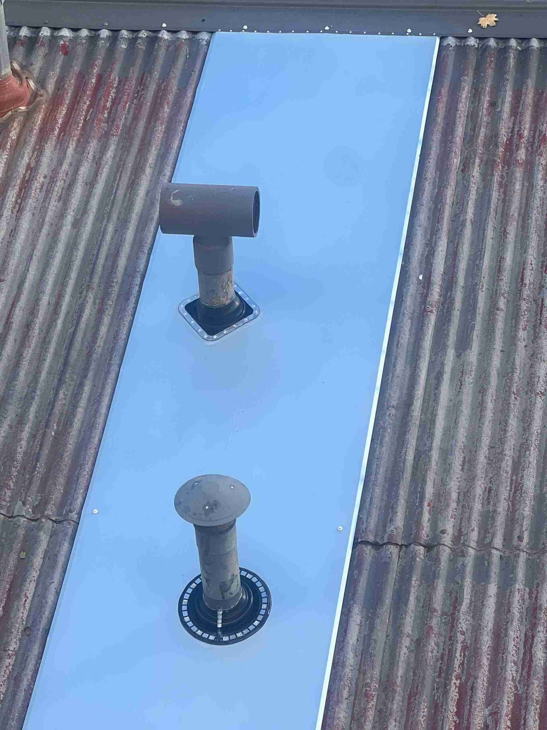 Dry pan flashing installation on a tile roof in Frankston showing metal pan system against wall junction